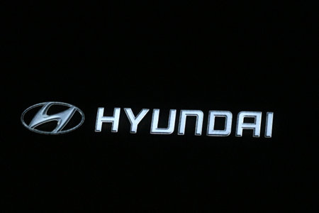 Bekasi, Indonesia in July 2022. The HYUNDAI logo shining brightly at night against the dark night sky. Hyundai Motor Company is a division of the Hyundai Kia Automotive Group as the largest car manufacturer in South Korea.のeditorial素材