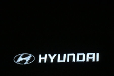 Bekasi, Indonesia in July 2022. The HYUNDAI logo shining brightly at night against the dark night sky. Hyundai Motor Company is a division of the Hyundai Kia Automotive Group as the largest car manufacturer in South Korea.のeditorial素材