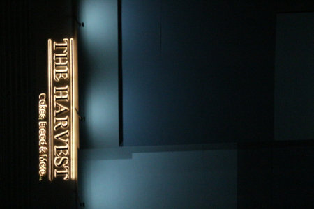 Bekasi, Indonesia in July 2022. The Harvest logo that shines brightly at night against the dark night sky. The Harvest is a pioneer brand in the field of pastry & bakery in Indonesia. With 57 stores throughout Indonesia, The Harvest continues to provide tのeditorial素材