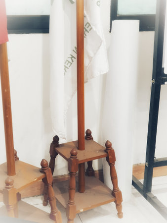 Photo of an indoor flagpole stand made of wood. It has four legs as a solid base so it doesn't fall easily. Very traditional with very good quality.の写真素材