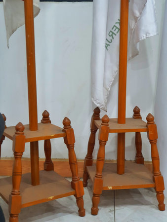 Photo of an indoor flagpole stand made of wood. It has four legs as a solid base so it doesn't fall easily. Very traditional with very good quality.の写真素材
