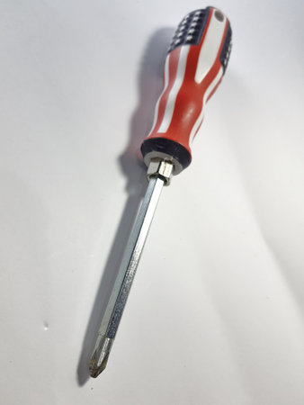 Isolated white photo of a steel screwdriver with a usa flag patterned handle.の写真素材