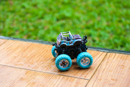 Mini monster truck toy with big blue wheels. Monster truck is a special off-road vehicle with...
