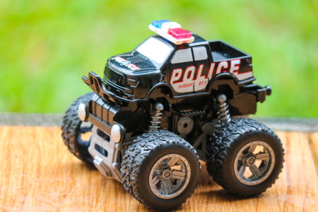 Mini police monster truck toy with big black wheels. Monster truck is a special off-road vehicle with heavy-duty suspension, four-wheel steering,の写真素材