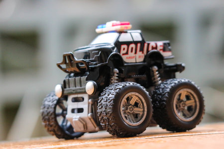 Mini police monster truck toy with big black wheels. Monster truck is a special off-road vehicle with heavy-duty suspension, four-wheel steering,の写真素材