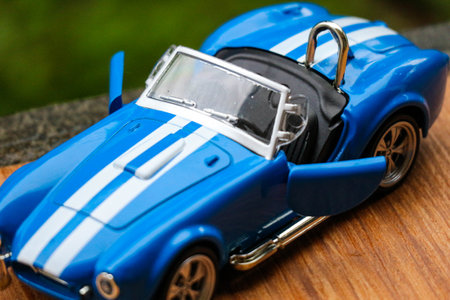 West Java, Indonesia in May 2022 Ford Cobra vintage toy racing car with bokeh background. Blue in color with white stripes, has 2 seats.のeditorial素材