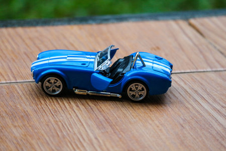 West Java, Indonesia in May 2022 Ford Cobra vintage toy racing car with bokeh background. Blue in color with white stripes, has 2 seats.のeditorial素材