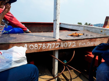 Cilegon, Indonesia in 2018. A passenger boat telephone number on Little Merak Island, Merak Harborのeditorial素材