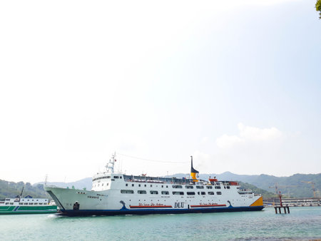 Cilegon, Indonesia in 2018. A passenger ferry with the name Kirana II Ship at Merak Harbor is passing by.のeditorial素材