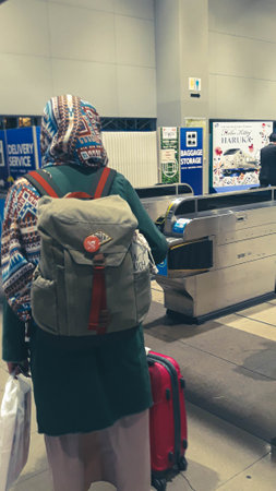 Osaka, Japan on April 8, 2019. Photo of an immigration checkpoint for foreigners at Kansai International Airport (Kansai Kokusai KÅ«kÅ). Several Asian tourist were walking towards immigration.のeditorial素材