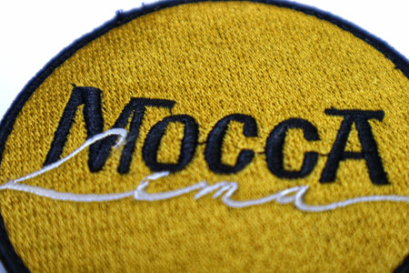 Jakarta, Indonesia in May 2022. The cloth embroidered emblem reads Mocca, one of the famous bands in Indonesia originating from Bandung. This emblem is yellow with black writing.のeditorial素材