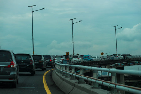 Close up photo of a back lamp of car that stuck in a traffic jam on the highway, with a bokeh background.の写真素材