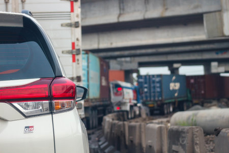 Close up photo of a back lamp of car that stuck in a traffic jam on the highway, with a bokeh background.の写真素材