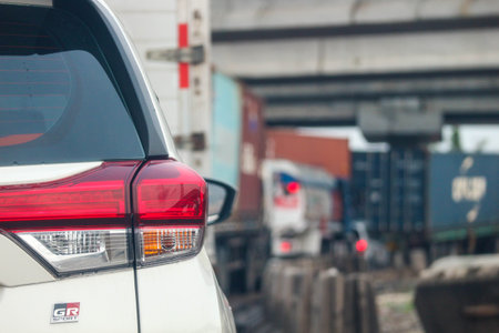Close up photo of a back lamp of car that stuck in a traffic jam on the highway, with a bokeh background.の写真素材