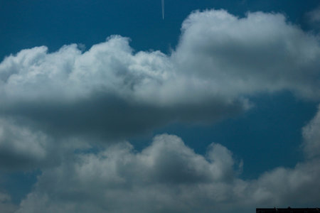 Big white clouds that look very soft against the bright blue sky. It's great to see. Suitable for your template background.の写真素材