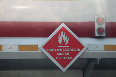 A warning sign for a fuel tank, namely a combustible fuel sign, made of a rhombus-shaped steel plate...