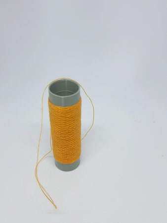 Isolated white photo of a blue sewing thread. With copy space.の写真素材