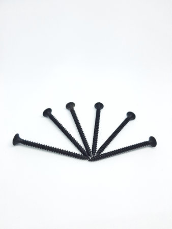 An isolated white photo of six black bolts with sharp edges that will be used to mount a shelf on the wall.の写真素材