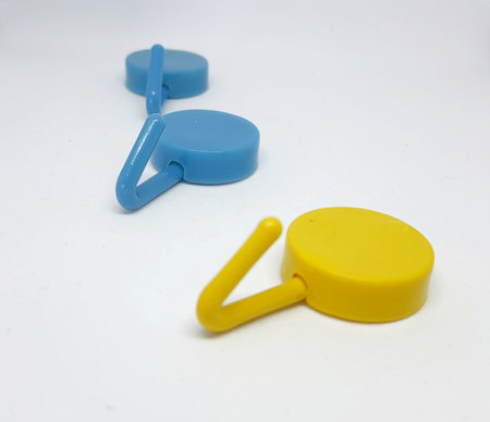 Isolated white photo of three round coat hangers with blue and yellow colors. Two blue one yellow.の写真素材