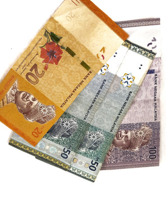 Isolated white photo of some malaysian ringgit banknotes. One 100 note, two 50 notes and one 20 ringgit note.の写真素材