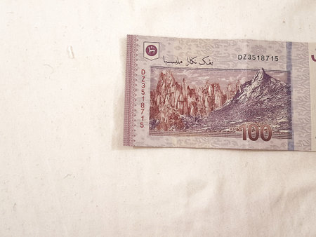 Isolated white photo of one piece of 100 ringgit malaysian bank notes. Suitable illustration for malaysian finance or personal finance.の写真素材