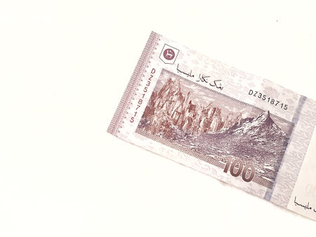 Isolated white photo of one piece of 100 ringgit malaysian bank notes. Suitable illustration for malaysian finance or personal finance.の写真素材