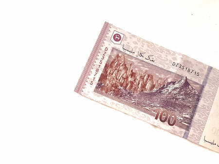 Isolated white photo of one piece of 100 ringgit malaysian bank notes. Suitable illustration for malaysian finance or personal finance.の写真素材