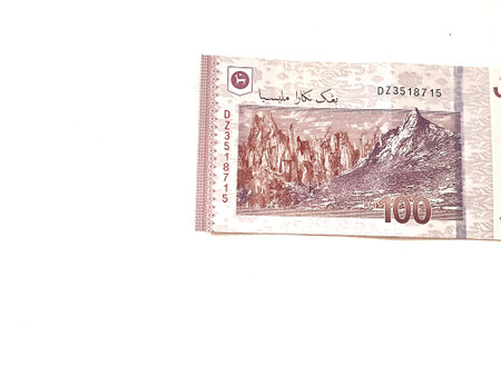 Isolated white photo of one piece of 100 ringgit malaysian bank notes. Suitable illustration for malaysian finance or personal finance.の写真素材