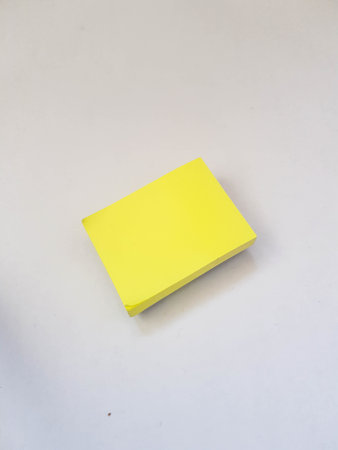 Isolated white photo of a yellow sticky note. These sticky notes look floating. It is suitable for templates to write your short messages or write favorite quotes.の写真素材
