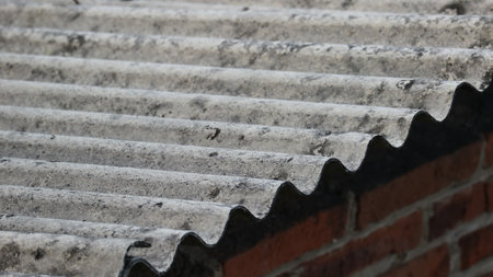 Asbestos roof tiles that have started to become ugly, originally gray in color are starting to show black spots.の写真素材