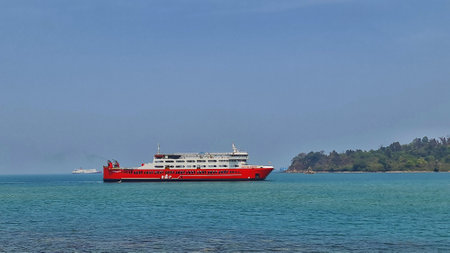 Merak, Indonesia on June 8 2023. A red ferry boat is heading towards the port of Merak. RAP Ferry ship that have jargon "We Serve The Nation"の写真素材