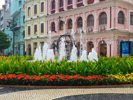 Largo do Senado, Macau on 14 Nov 2024. Macau's Senado SquareA refreshing fountain in Macau's heart, surrounded by colorful pastel buildings and vibrant flowers. The scene is tranquil and beautifully landscaped.の写真素材
