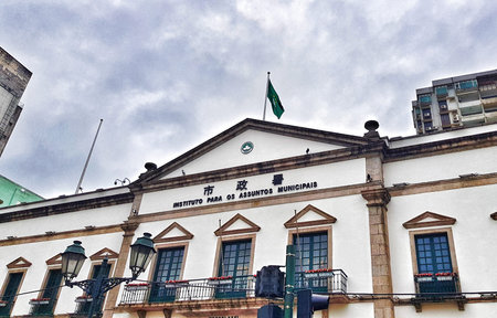 Macau, China on 14 Nov 2024. A majestic white colonial building in Macau stands tall under a cloudy...