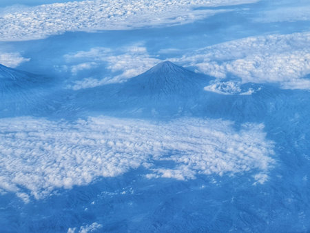 Stunning aerial shot showcasing mountain peaks emerging above a sea of clouds Use this for travel...