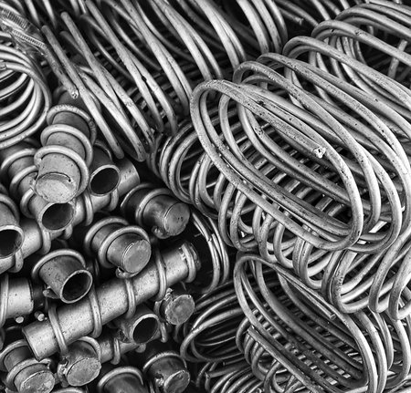 Detailed monochrome shot of coiled metal and cylinders creating an industrial textured effect and ideal for backgrounds or abstract concepts.の写真素材