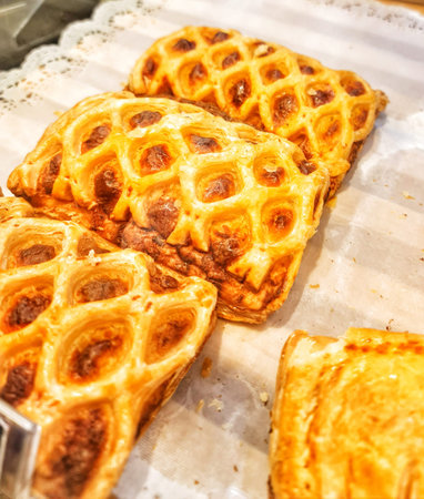Close up shot of baked turnovers with golden crust on display ready to serve Perfect for food presentation or culinary blog.の写真素材