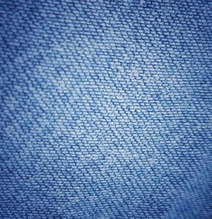 Close up of blue denim showing fine thread detail creating a textured pattern which can be used for backgrounds and designs.の写真素材