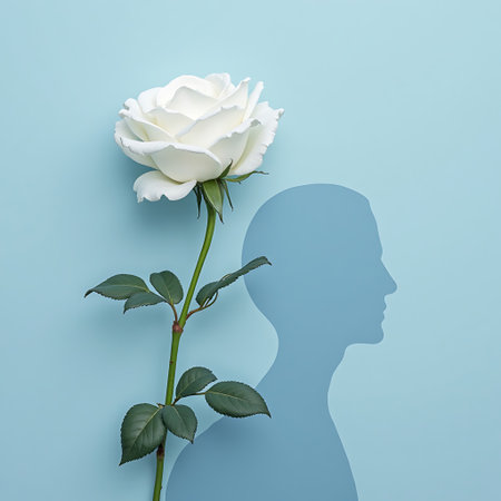 Elegant white rose juxtaposed with a light blue silhouette of a human head evoking thought and beauty Perfect for conceptual artwork or serene designs.の素材