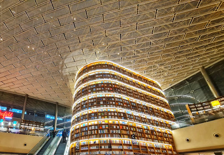 Seoul, South Korea on 7 Nov 2024. Magnificent bookshelf tower full of books stands within a bright modern retail building, evoking a sense of learning and grandiosity suitable for architectural and interior design marketing.のeditorial素材