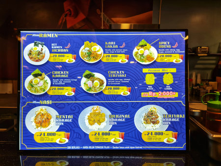 Bekasi, Indonesia on 9 Nov 2025. Illuminated menu board displays ramen and donburi choices at a casual eatery Perfect for showcasing food options and dining experiences.のeditorial素材