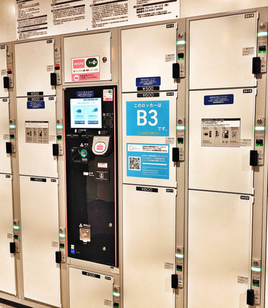 Tokyo, Japan on 20 Oct 2025. Rows of clean, white storage lockers and integrated payment machine are...