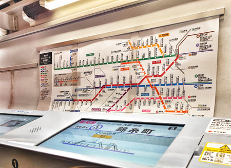 Tokyo, Japan on 20 Oct 2025. Colorful Tokyo Metro map displayed in a busy subway station with...
