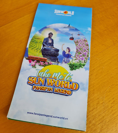Sapa, Vietnam on 15 May 2025. A brochure is displayed, highlighting a Buddha statue and a cable car...