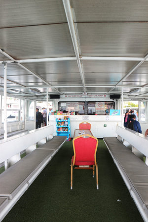 Istanbul, Turkey on 12 July 2022. Inside view of a passenger boat features benches, chairs, and a refreshment area making it suitable for travel and ferry related content.のeditorial素材