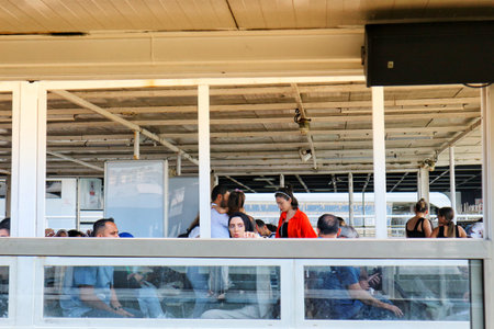 Istanbul, Turkey on 12 July 2022. Group of people visible through the boat windows are relaxing and enjoying their travel during daytime Good for travel and lifestyle shots.のeditorial素材