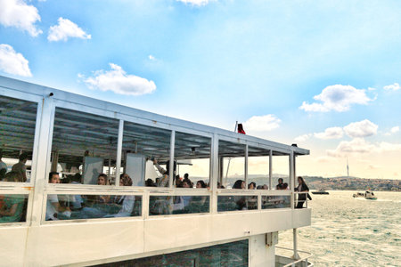 Istanbul, Turkey on 12 July 2022. Passengers relaxing on a boat enjoying the sea view with a clear sky perfect for travel and tourism-related content.のeditorial素材