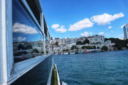 Istanbul, Turkey on 12 July 2022. Sailing on a boat on a sunny day reveals cityscape and reflections on the windows Enjoy travel and sightseeing with this image.のeditorial素材