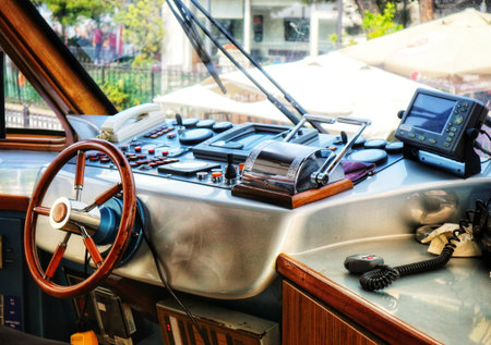 Istanbul, Turkey on 12 July 2022. Interior shot of boat with a steering wheel and various controls in bright sunlight, perfect for boating and travel themes.のeditorial素材