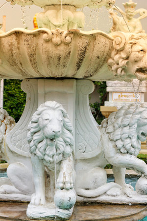 Bangkok, Thailand on 25 July 2023. Elaborate white stone fountain features lion sculptures dispensing water into a tiered basin, creating a peaceful and elegant outdoor scene Perfect for garden and architectural design.のeditorial素材