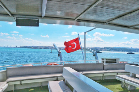 Istanbul, Turkey on 12 July 2022. View from a deck on a ship sailing on clear blue waters with the shore in the distance offering a serene travel experience ideal for destination imagery.のeditorial素材